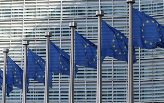 Flags of the European Union as the first regulations from the EU AI Act come into force with policies that set strict rules on how businesses use the technology for their operations and severe penalties for failures.