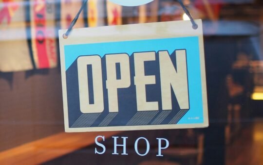 Open shop sign in a store as SAP and Google Cloud are deploying agentic commerce architecture to automate multi-agent marketing and retail operations at enterprise scale.