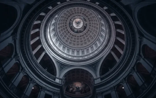 US Capitol dome interior with dramatic lighting showing legislative architecture and political tension