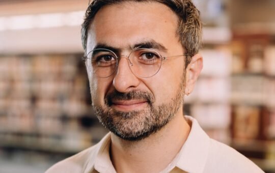 Photo of Microsoft AI CEO Mustafa Suleyman as he warns that Anthropic risks AI alignment failures by training Claude to view itself as a conscious entity deserving of legal rights.